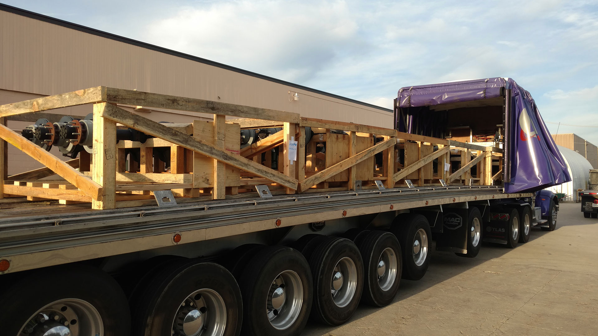 Image of atlas company truck shipping truck axles.