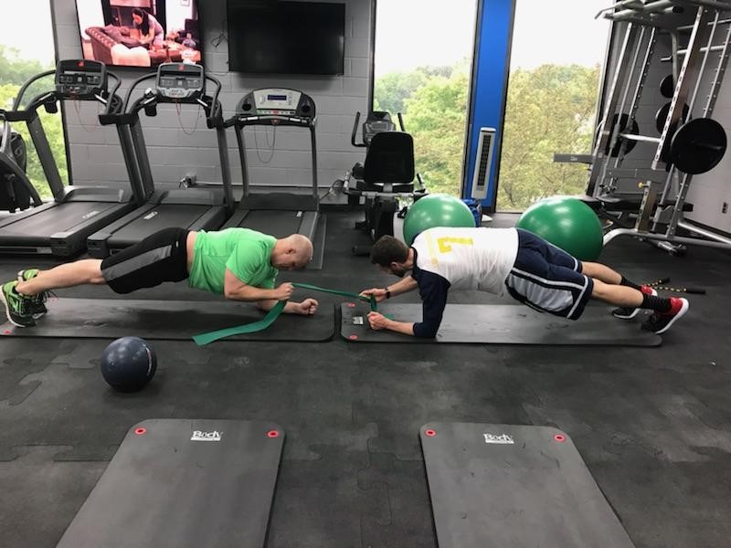 Two men working out in the ADICA gym.