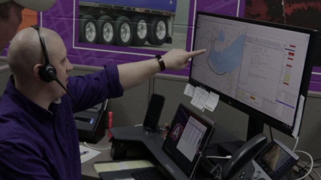worker viewing logistics on computer