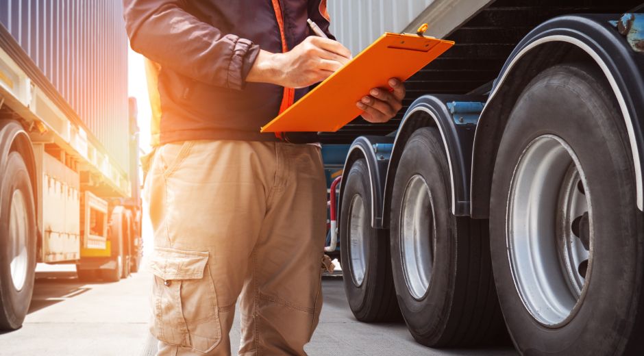 Fleet inspector completing a commercial truck inspection checklist to prepare for International Roadcheck 2026.